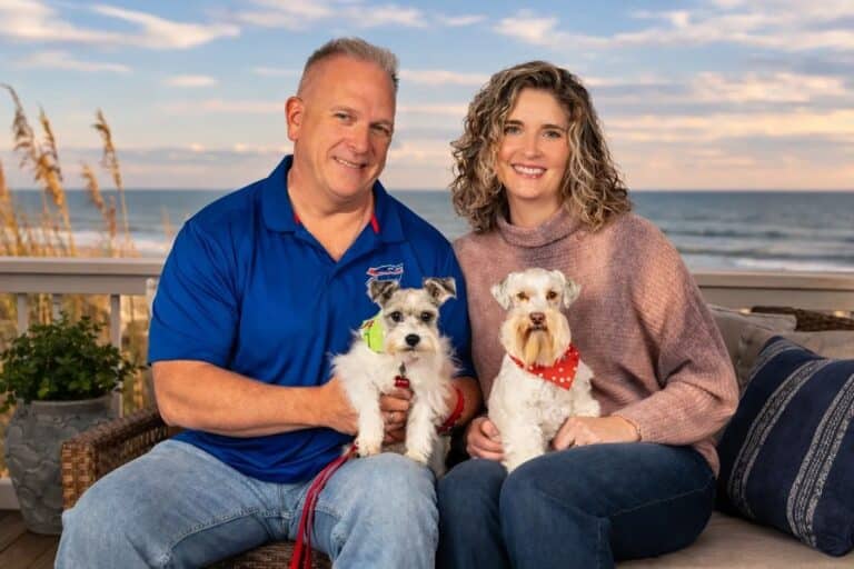 Michael and Dena with their dogs on an oceanfront balcony in Myrtle Beach